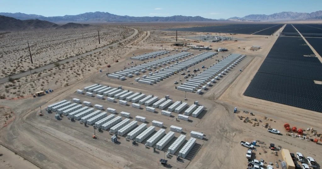 Vista aérea de fileiras de containers de baterias BESS junto a parque solar fotovoltaico no deserto da Califórnia